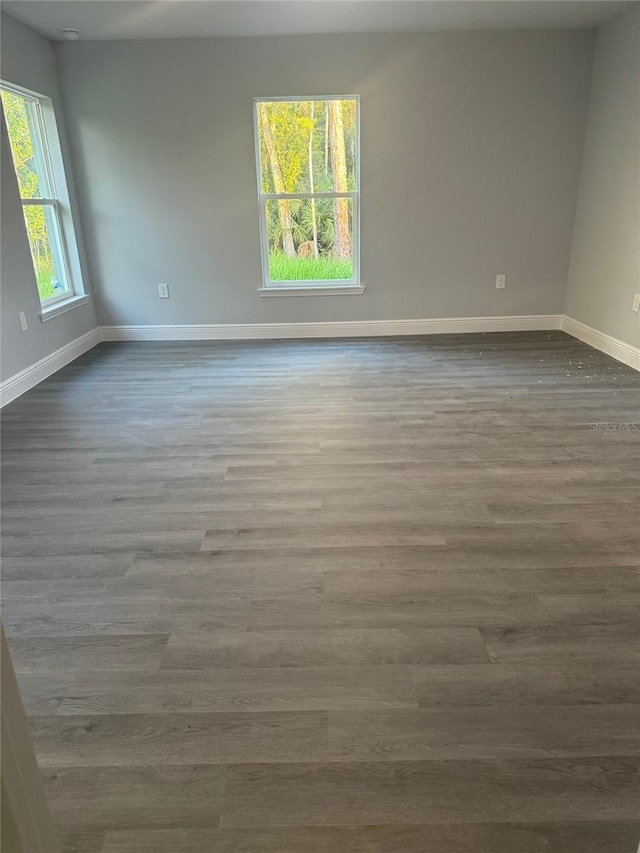 unfurnished room with hardwood / wood-style flooring