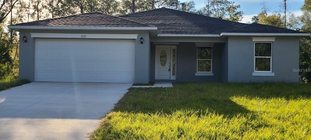 ranch-style house featuring a front lawn and a garage