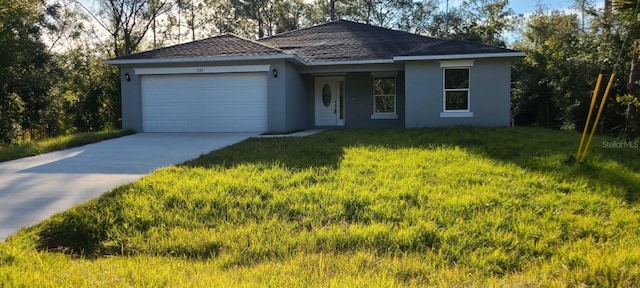 ranch-style house featuring a garage and a front lawn