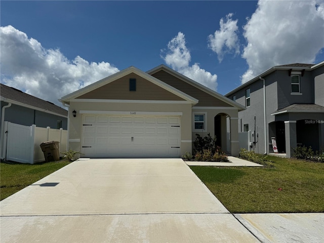 view of front of property featuring a front yard and a garage