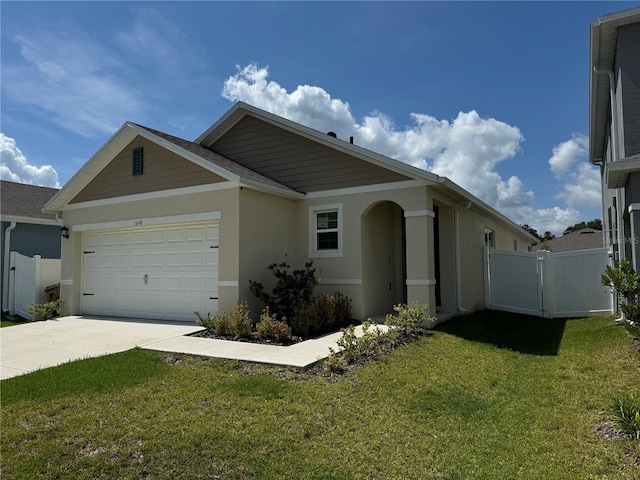 view of front of property with a garage and a front lawn