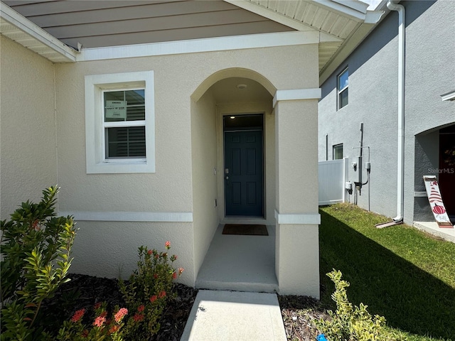 doorway to property featuring a lawn