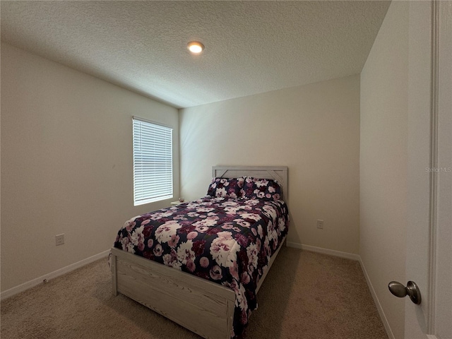 carpeted bedroom featuring a textured ceiling