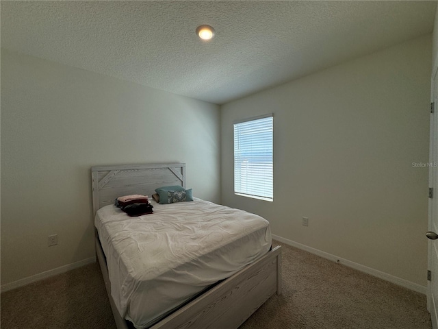 carpeted bedroom with a textured ceiling