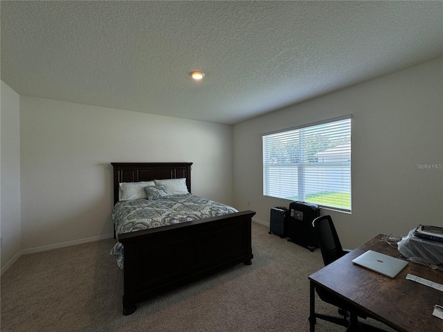 carpeted bedroom with a textured ceiling