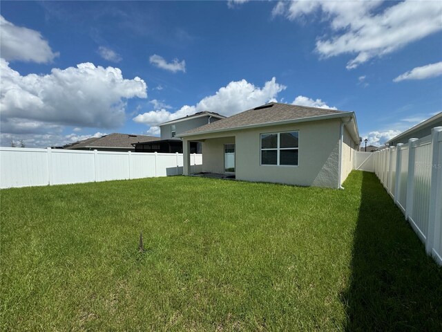 back of house with a yard