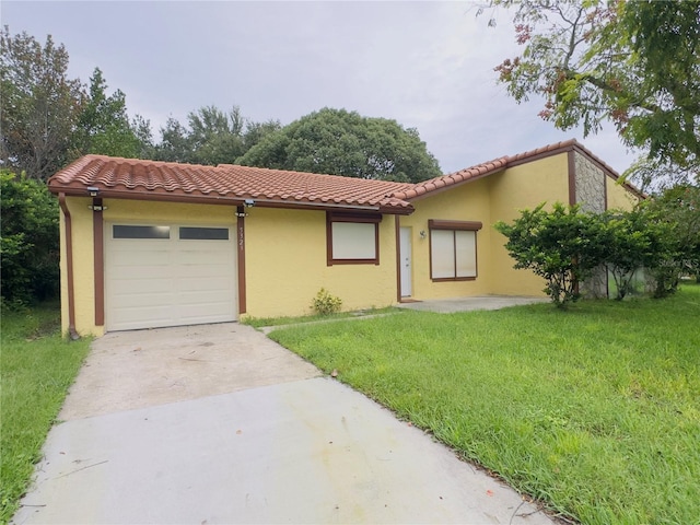 view of front of home with a garage and a front lawn