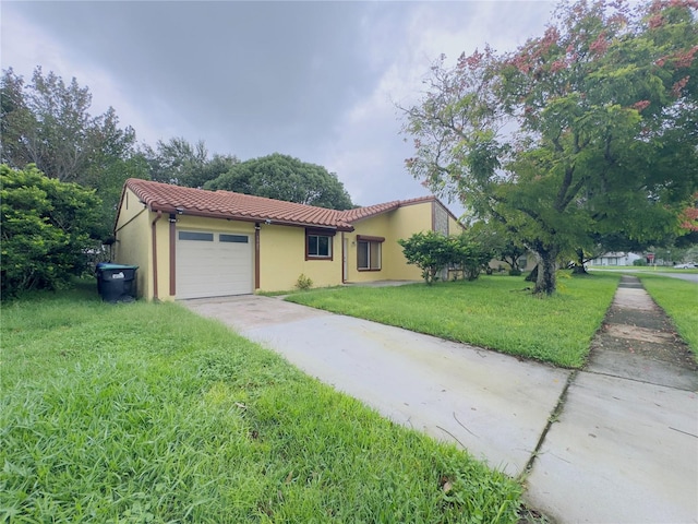 view of front of property with a front yard and a garage