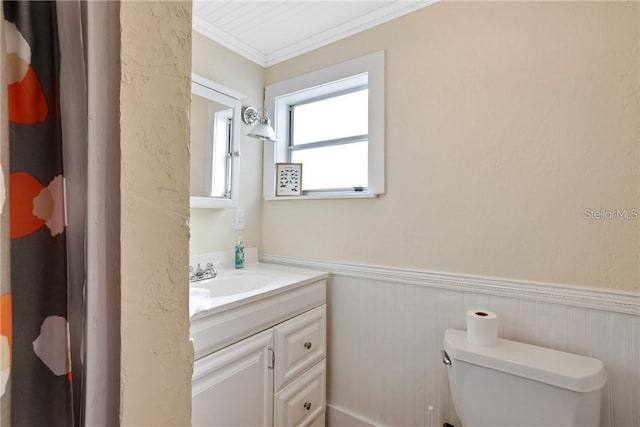 bathroom featuring vanity, ornamental molding, and toilet