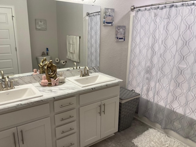 bathroom with tile patterned floors and vanity