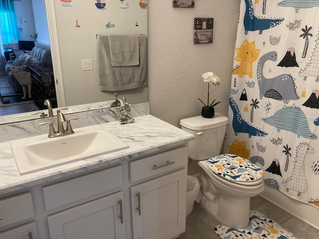 bathroom featuring tile patterned flooring, a shower with curtain, vanity, and toilet