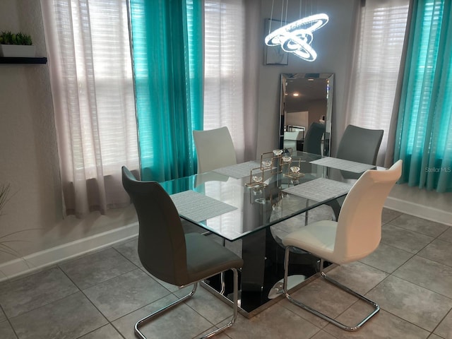 dining space with tile patterned flooring