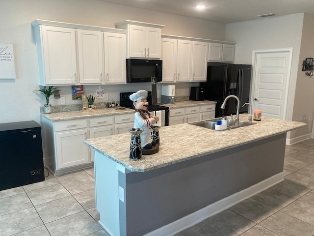 kitchen featuring white cabinetry, sink, black appliances, and a center island with sink