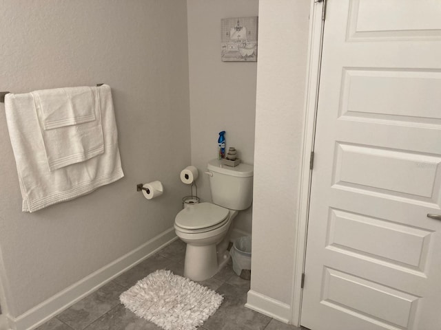 bathroom featuring toilet and tile patterned floors