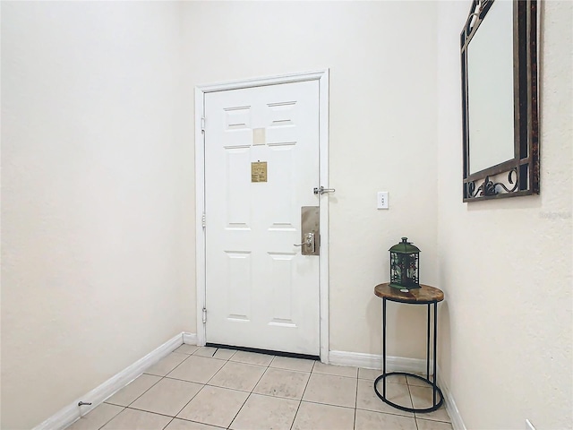 doorway to outside with light tile patterned floors