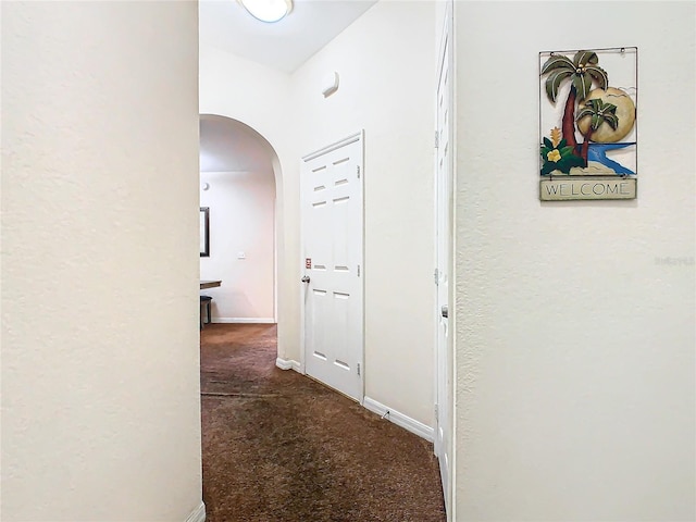 hallway with dark carpet