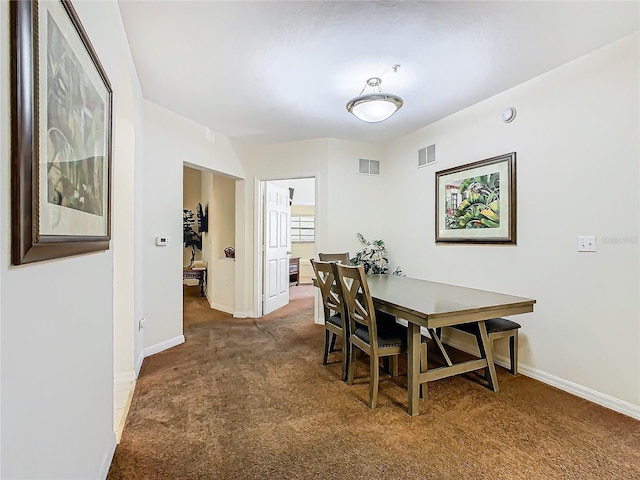 dining area with dark colored carpet