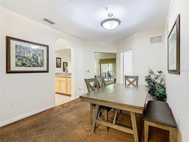 dining area featuring light colored carpet