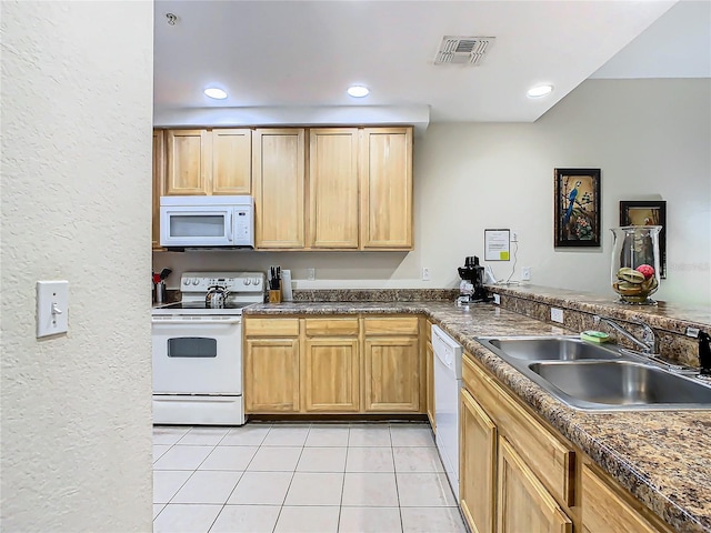 kitchen with sink, light tile patterned flooring, and white appliances