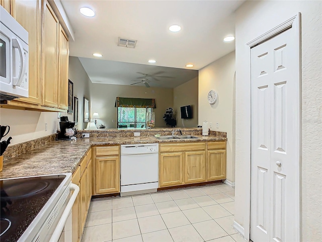 kitchen featuring light brown cabinets, kitchen peninsula, sink, light tile patterned floors, and white appliances