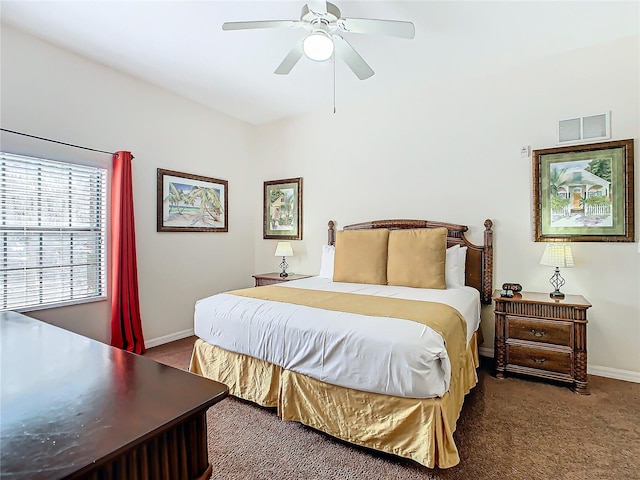 bedroom with ceiling fan and dark carpet