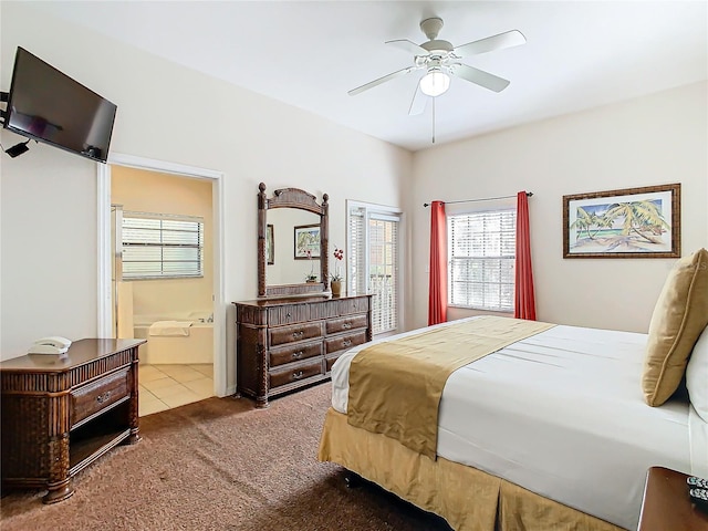 carpeted bedroom with ensuite bathroom and ceiling fan