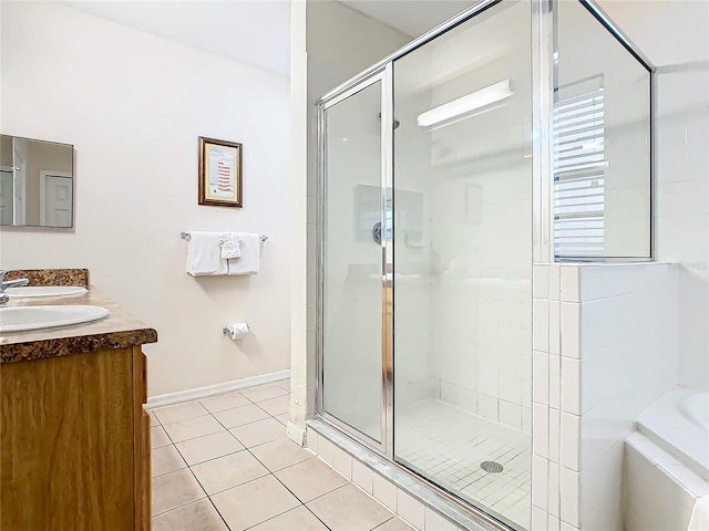 bathroom featuring vanity, tile patterned flooring, and plus walk in shower