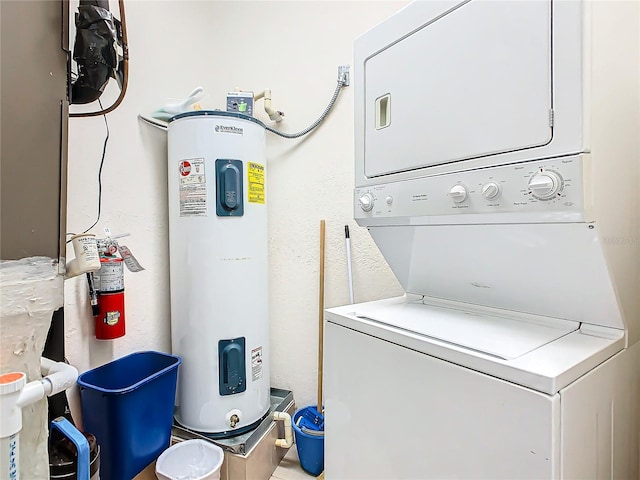 clothes washing area featuring water heater and stacked washer / drying machine