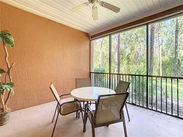 sunroom featuring ceiling fan