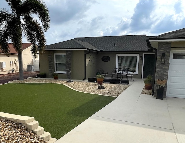 ranch-style house featuring cooling unit and a garage