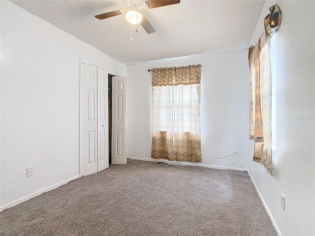 empty room featuring carpet and ceiling fan