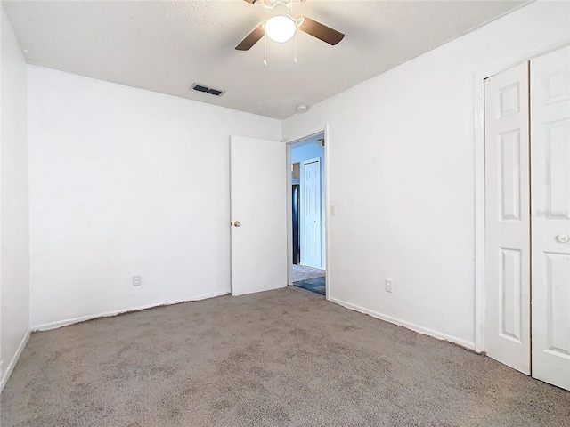 unfurnished bedroom featuring a closet, ceiling fan, and carpet flooring