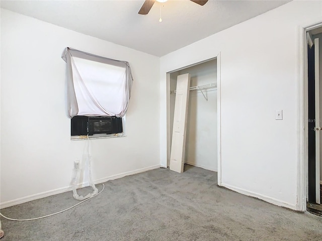 unfurnished bedroom featuring light carpet, cooling unit, a closet, and ceiling fan