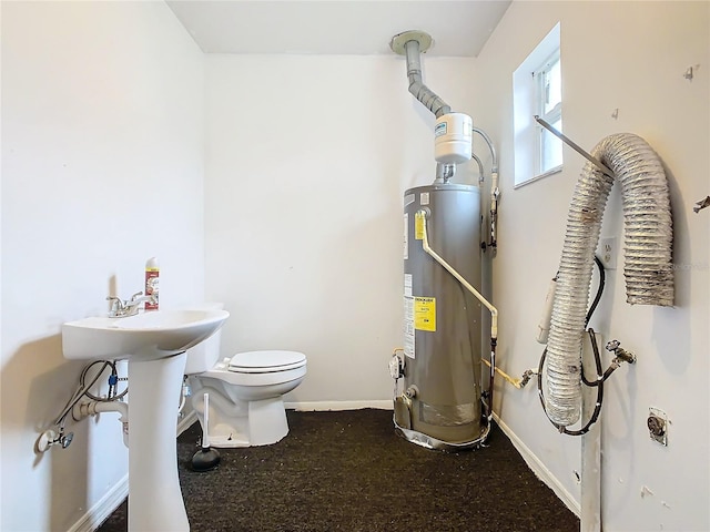 bathroom featuring toilet and water heater