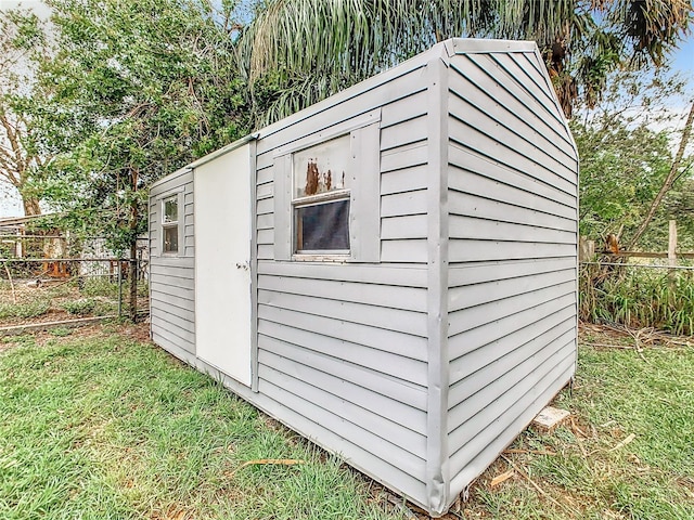 view of shed featuring fence