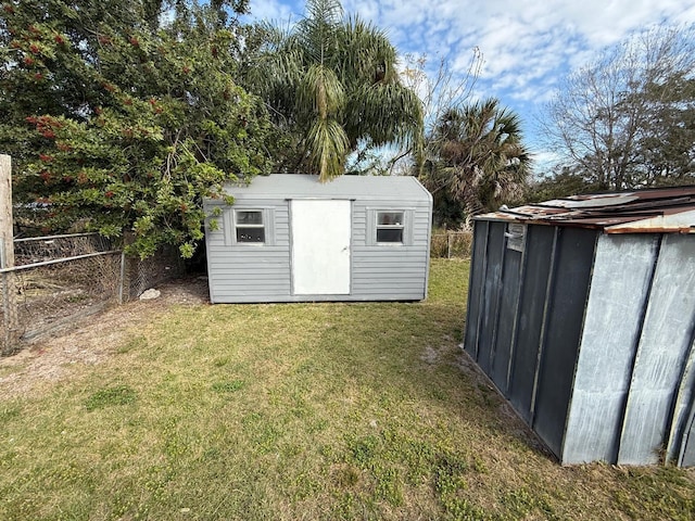 view of shed featuring fence