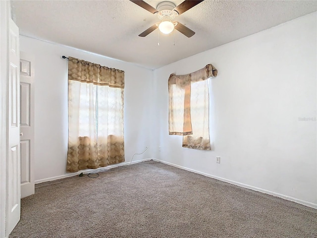 spare room featuring a ceiling fan, carpet flooring, a textured ceiling, and baseboards