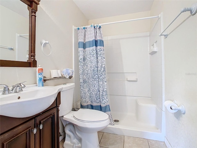 bathroom with toilet, tile patterned flooring, vanity, and a shower stall