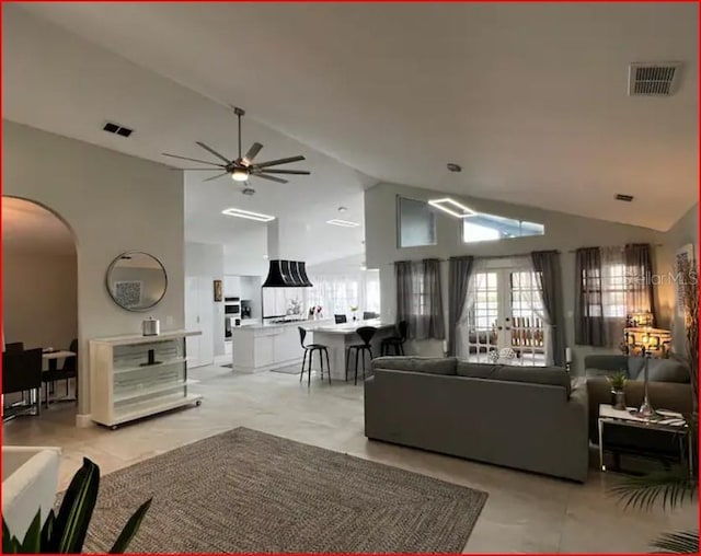 living room featuring high vaulted ceiling and ceiling fan