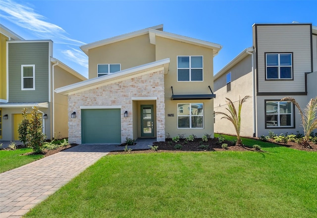 view of front of property with a front yard and a garage