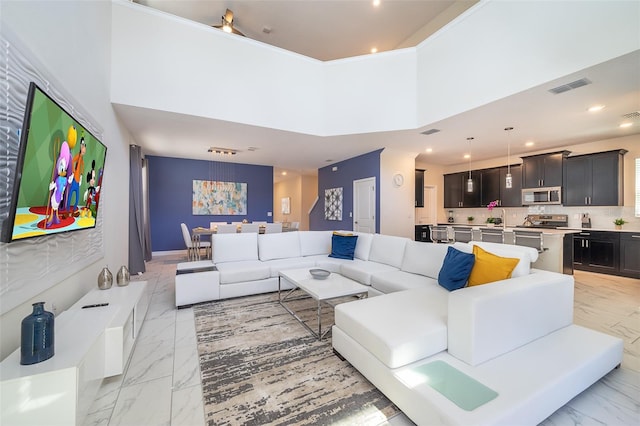 living room featuring a towering ceiling