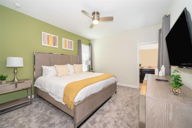 carpeted bedroom featuring ceiling fan and sink