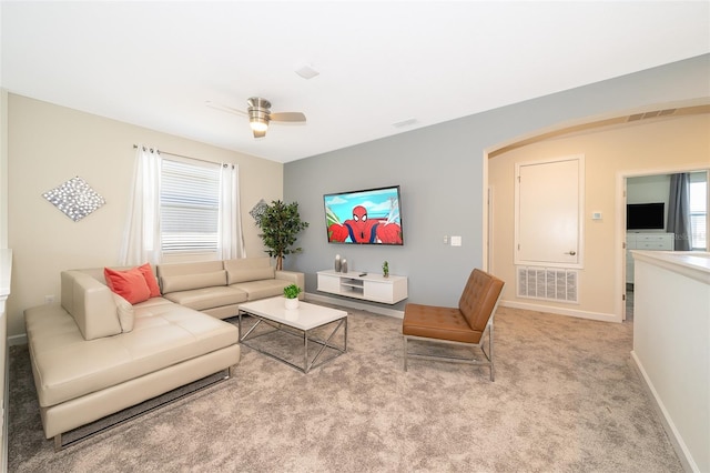 carpeted living room with a wealth of natural light and ceiling fan