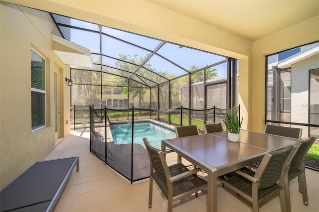 view of pool featuring a patio area and glass enclosure