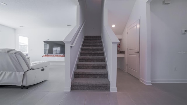 stairs with tile patterned flooring