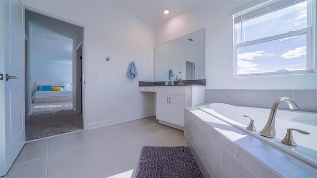 bathroom with vanity, tiled bath, and tile patterned floors