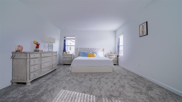 bedroom with light colored carpet and multiple windows