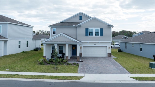 craftsman-style home featuring a garage, cooling unit, and a front lawn