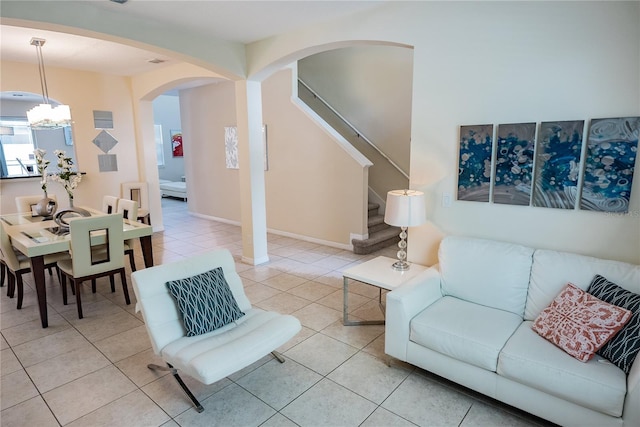 living room with a chandelier and light tile patterned floors