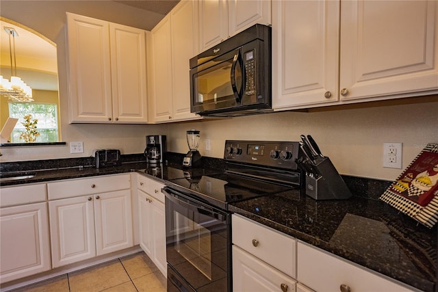 kitchen with black appliances, decorative light fixtures, and white cabinets